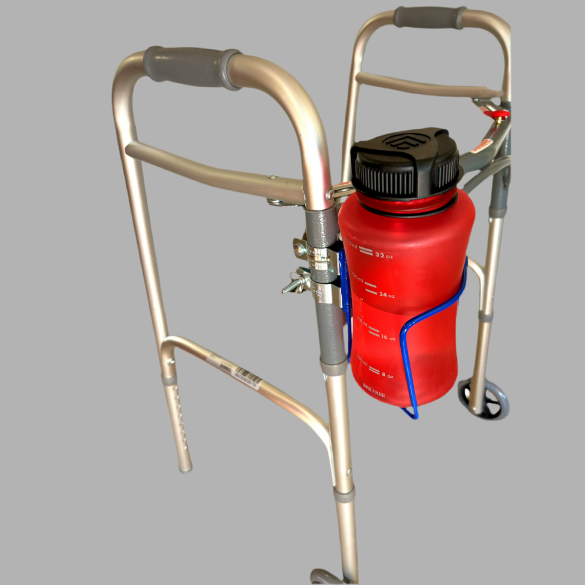 Red bottle attached to a metal walker on a gray background