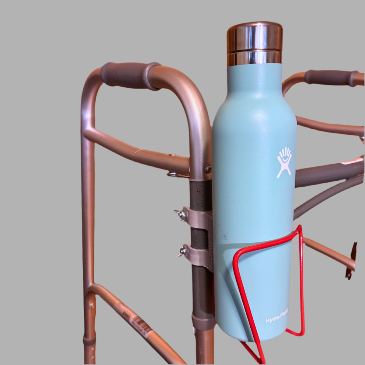 Light blue water bottle with a logo attached to a walker.