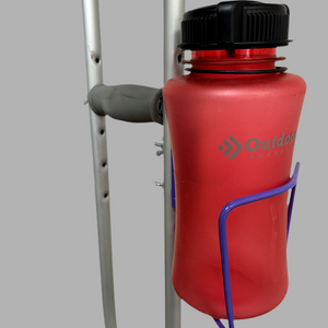 Durable aluminum cup holder bolted to crutches, holding a red water bottle for versatile drink access.