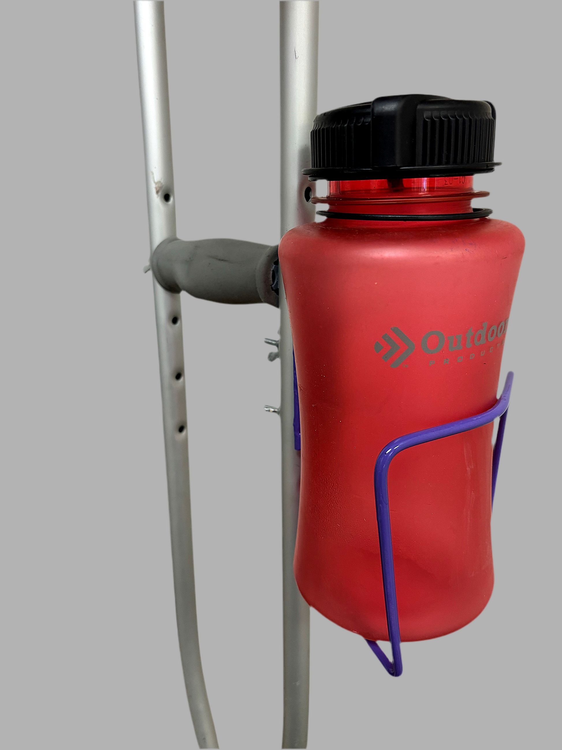 Durable aluminum cup holder bolted to crutches, holding a red water bottle for versatile drink access.