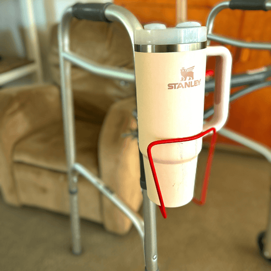 Walker cup holder securely holding a Stanley drink mug, designed for walkers, made of lightweight aluminum for convenience.